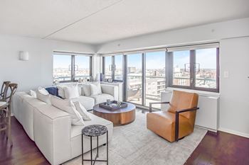 A living room with white couches and a coffee table
